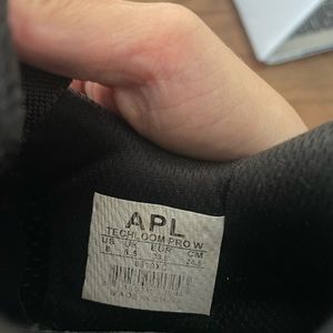 Women’s black APL Techloom Pro sneakers.